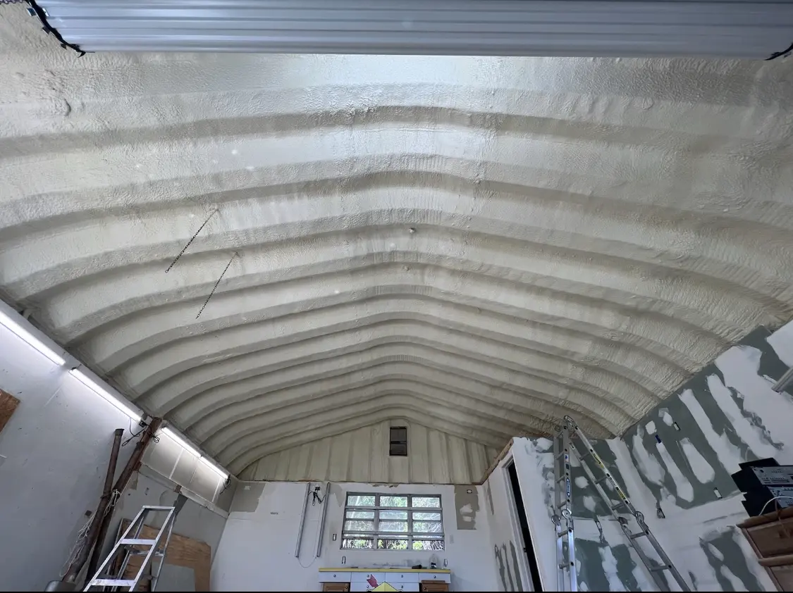 Spray polyurethane foam applied to the underside of a metal roof deck in Glasgow
